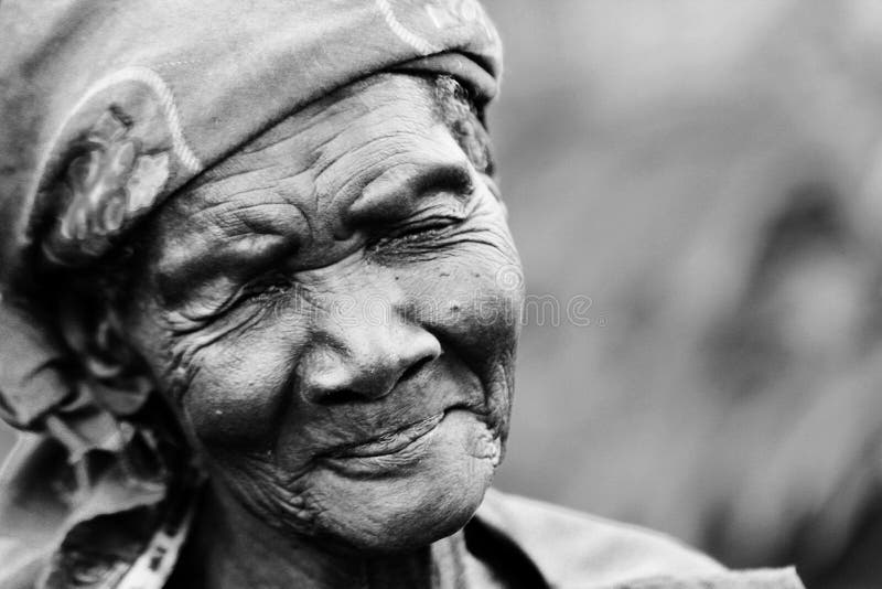 An elderly woman smiles with sadness and modesty in Gulu, Uganda. She is over 80 years old and. An elderly woman smiles with sadness and modesty in Gulu, Uganda. She is over 80 years old and